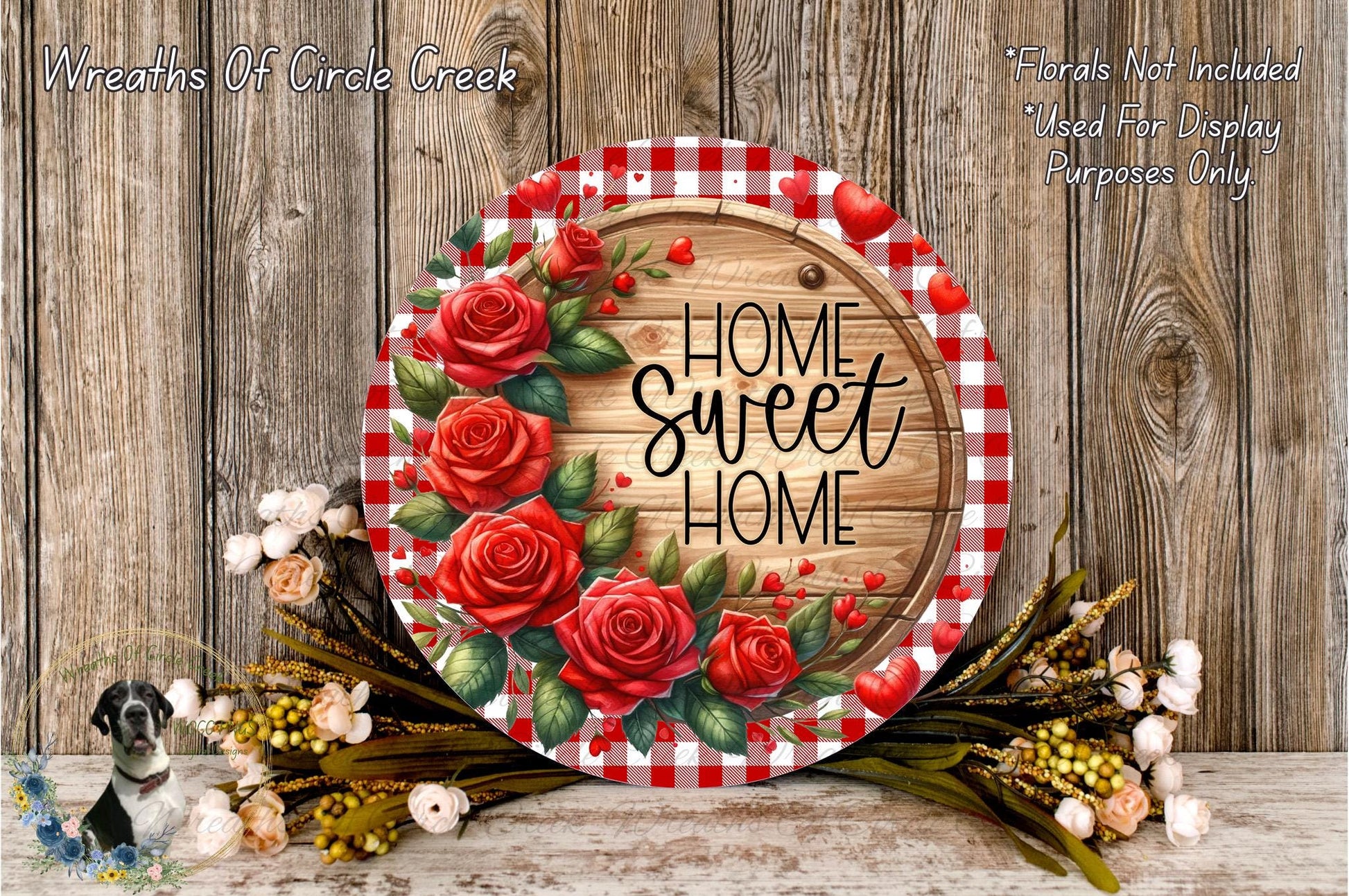a decorative wreath with a wooden board and red roses, surrounded by a floral arrangement and a wooden wall.