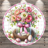 A round floral arrangement in a glass jar, with a pink bow and the word "Hello" written on a sign, surrounded by Easter eggs and flowers on a wooden background.