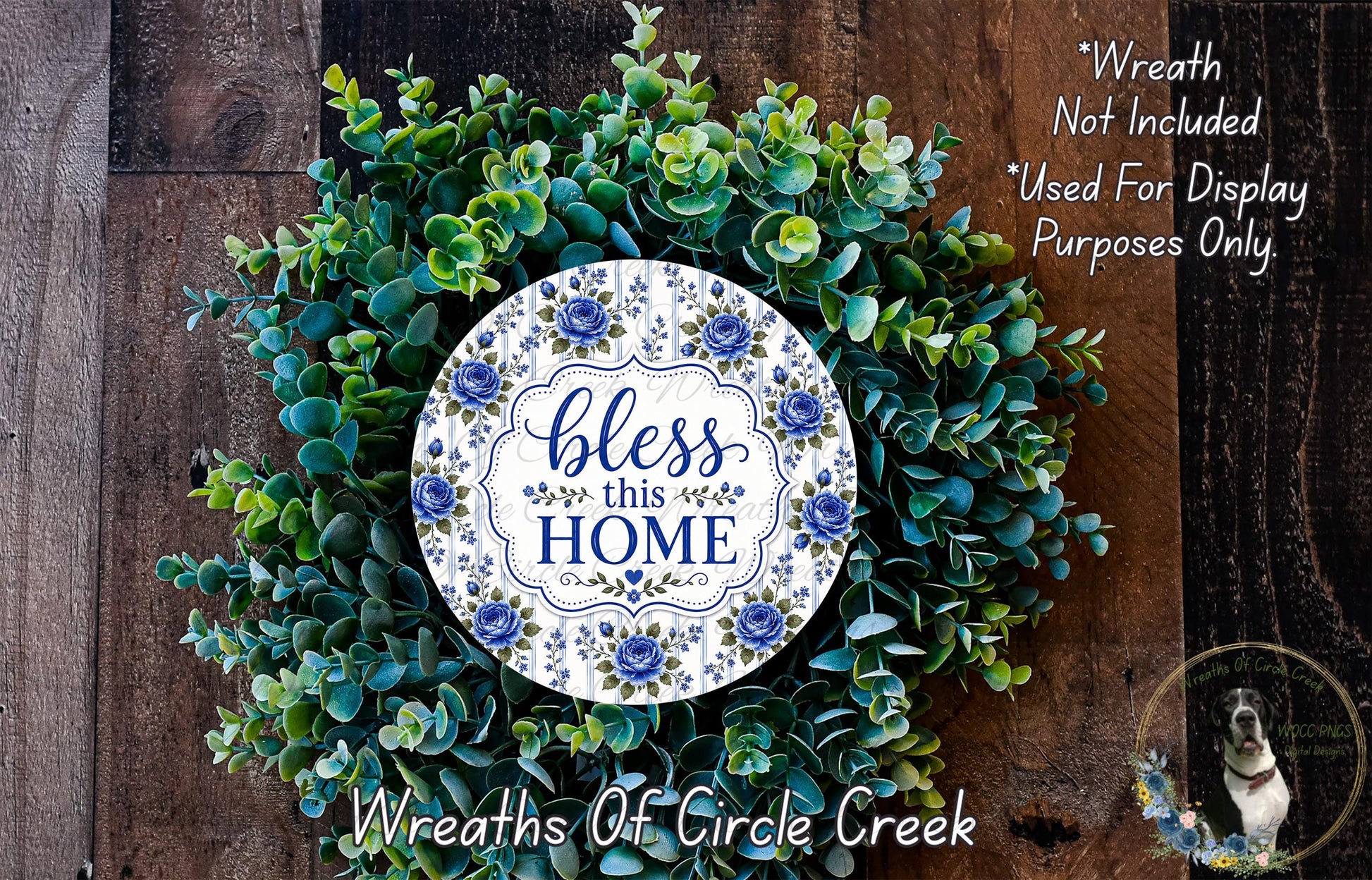 a wreath made of various green plants and flowers, with a decorative plate in the center that says "bless this home".
