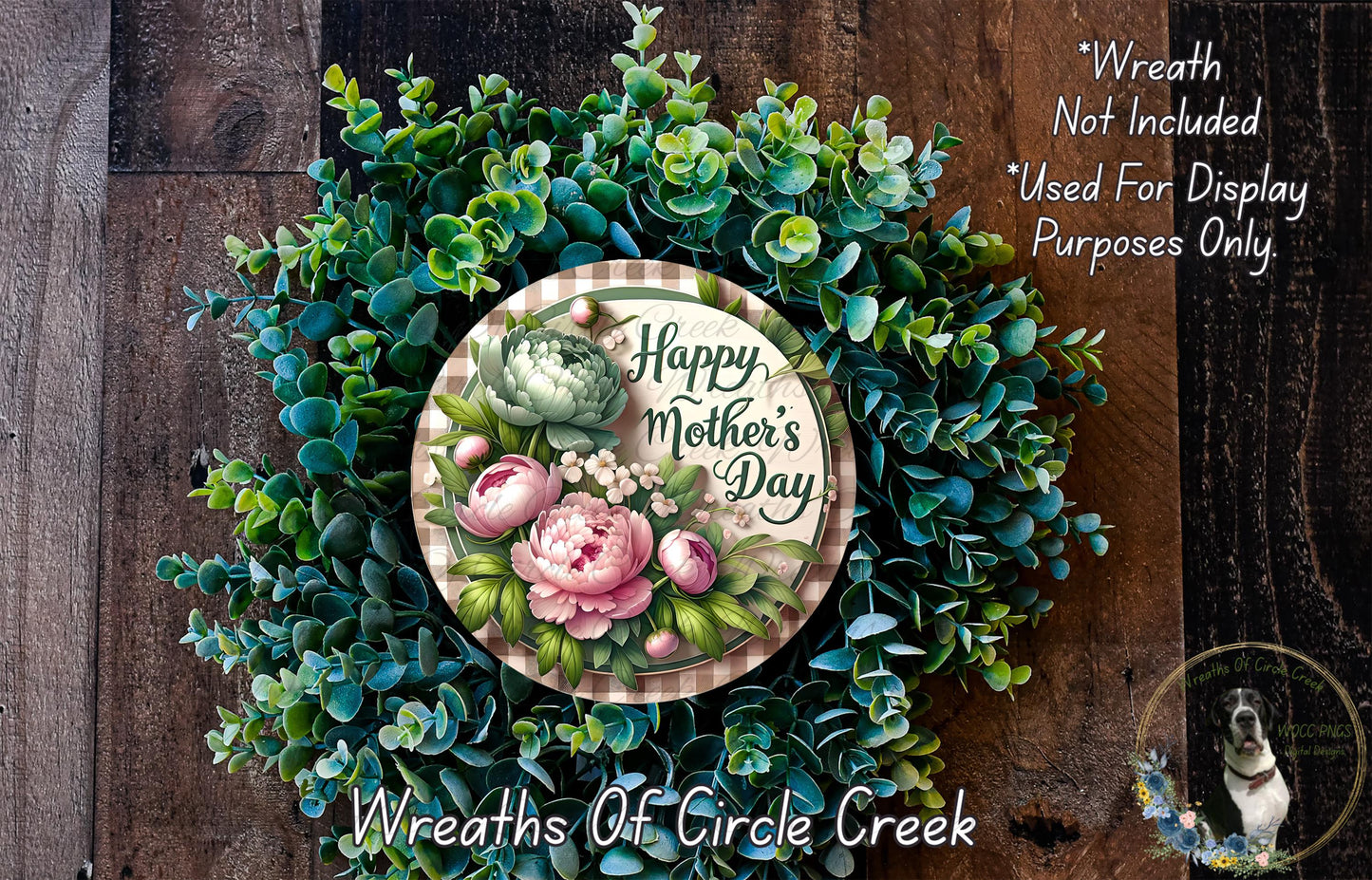 A wreath made of various green plants and flowers, with a circular sign that reads "Happy Mother's Day" in the center.