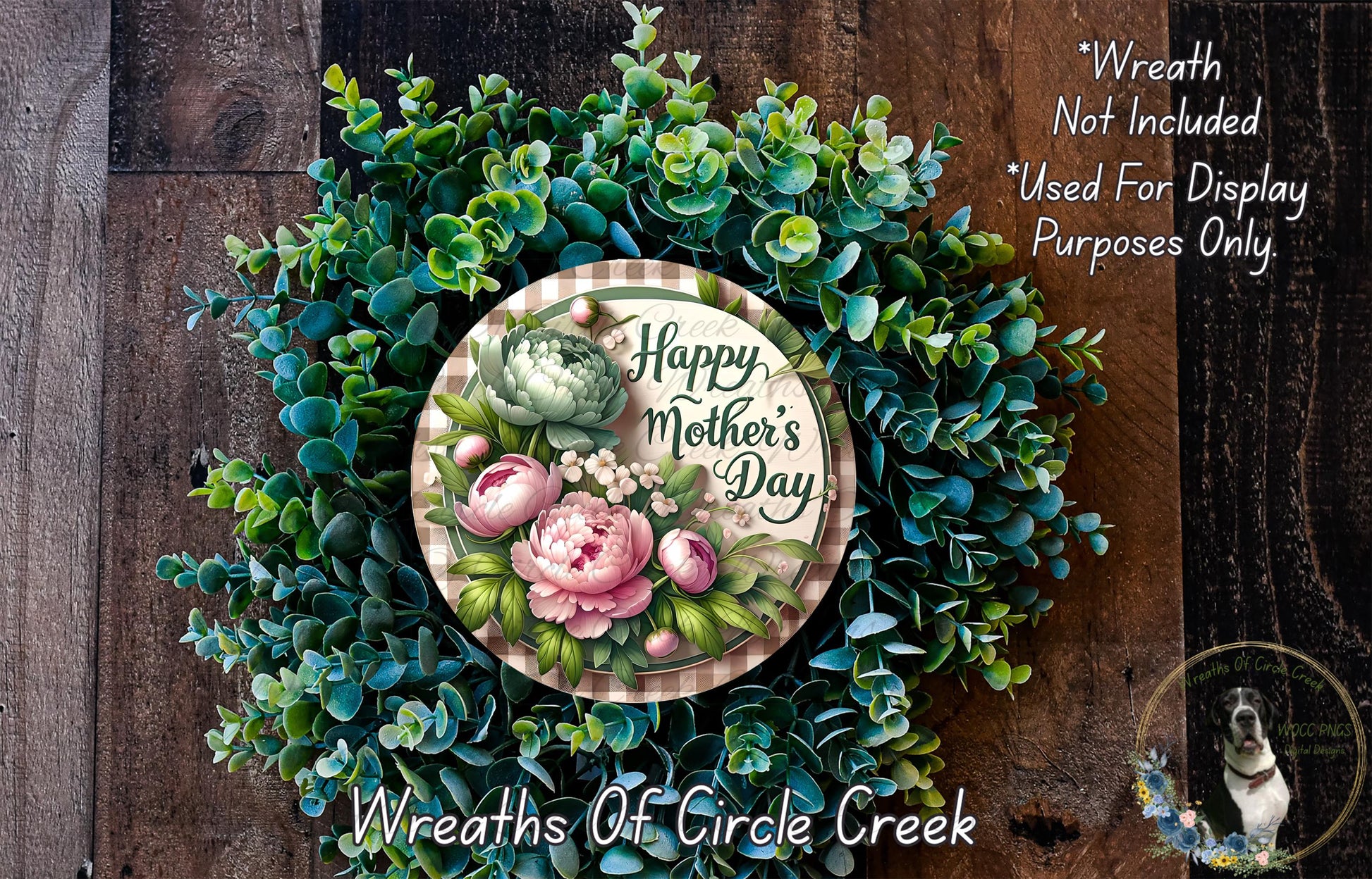 A wreath made of various green plants and flowers, with a circular sign that reads "Happy Mother's Day" in the center.