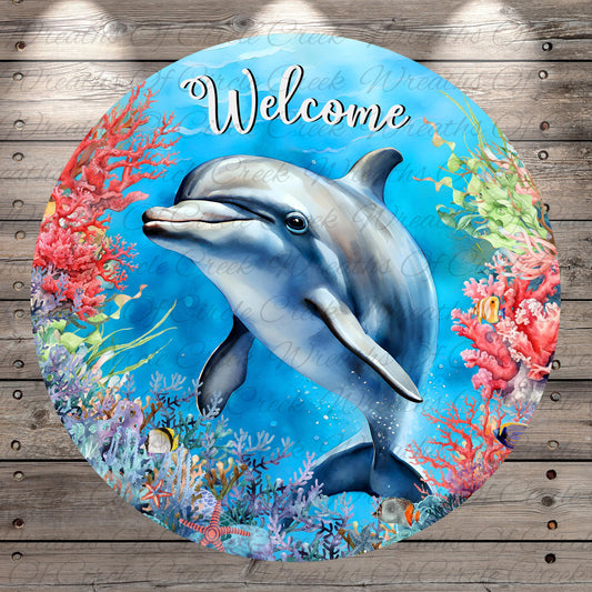 A round, colorful sign featuring a dolphin surrounded by vibrant coral and marine life, with the word "Welcome" written on it.