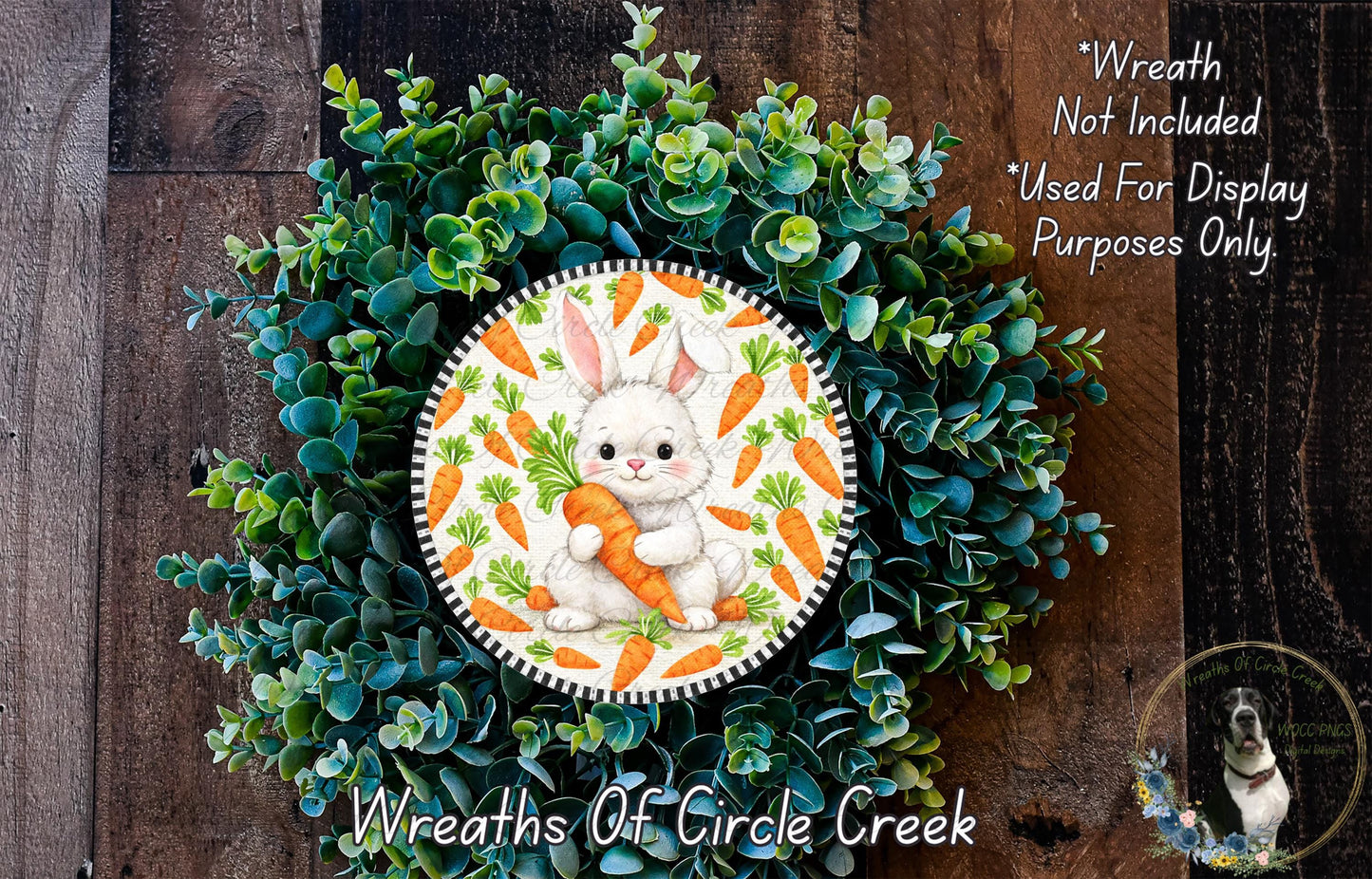 A wreath made of green leaves and orange carrots, featuring a white rabbit holding a carrot.