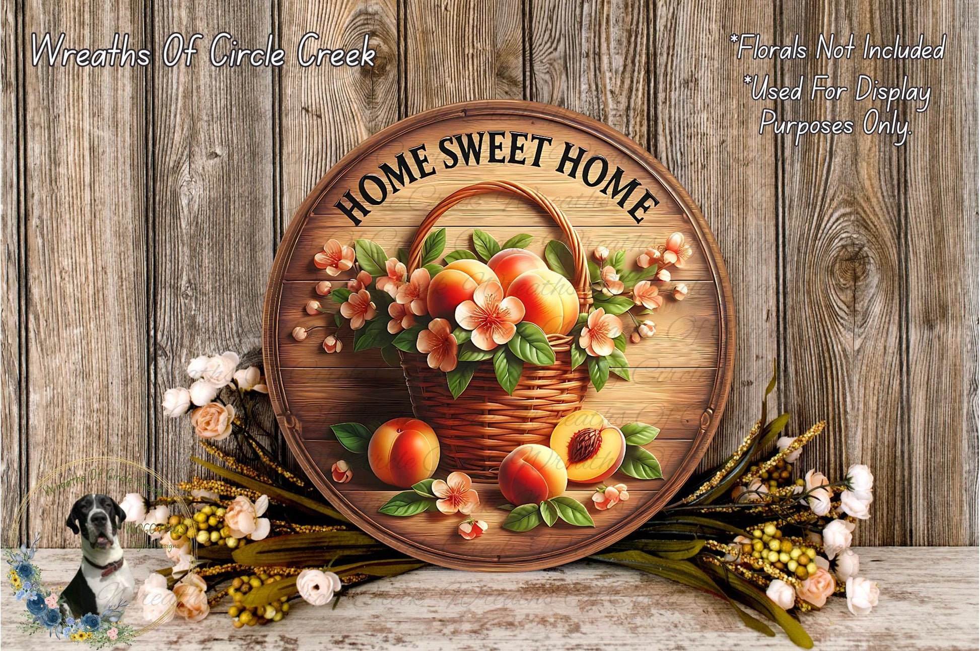 a wooden sign with a basket of peaches and flowers, surrounded by a wreath of flowers and leaves, all set against a wooden background.