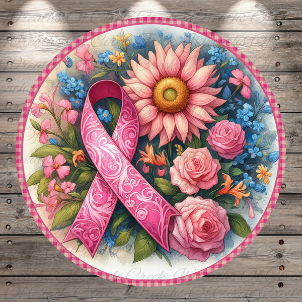 A pink ribbon, a symbol of breast cancer awareness, is surrounded by a vibrant floral arrangement of pink roses, blue forget-me-nots, and other colorful flowers on a wooden background.