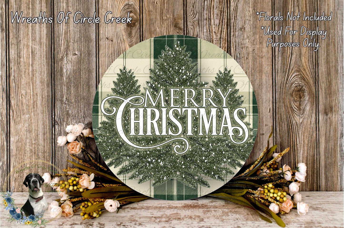 a festive Christmas-themed arrangement with a large circular sign displaying the text "Merry Christmas" surrounded by a wreath of greenery and flowers.