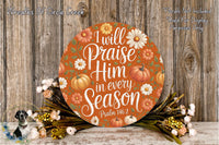 a circular sign with a floral design and text, surrounded by a wreath of flowers and greenery.