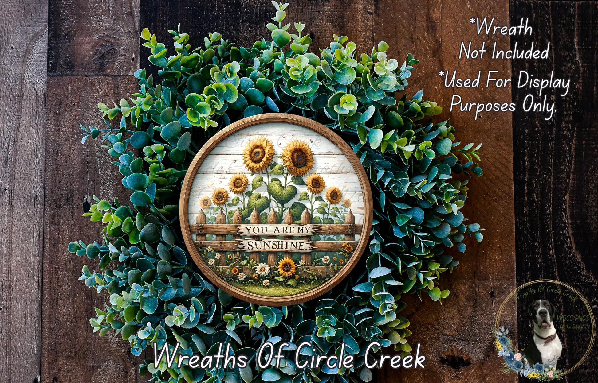 A wreath made of green foliage and yellow sunflowers, with a wooden frame displaying the text "You are not sunshine".