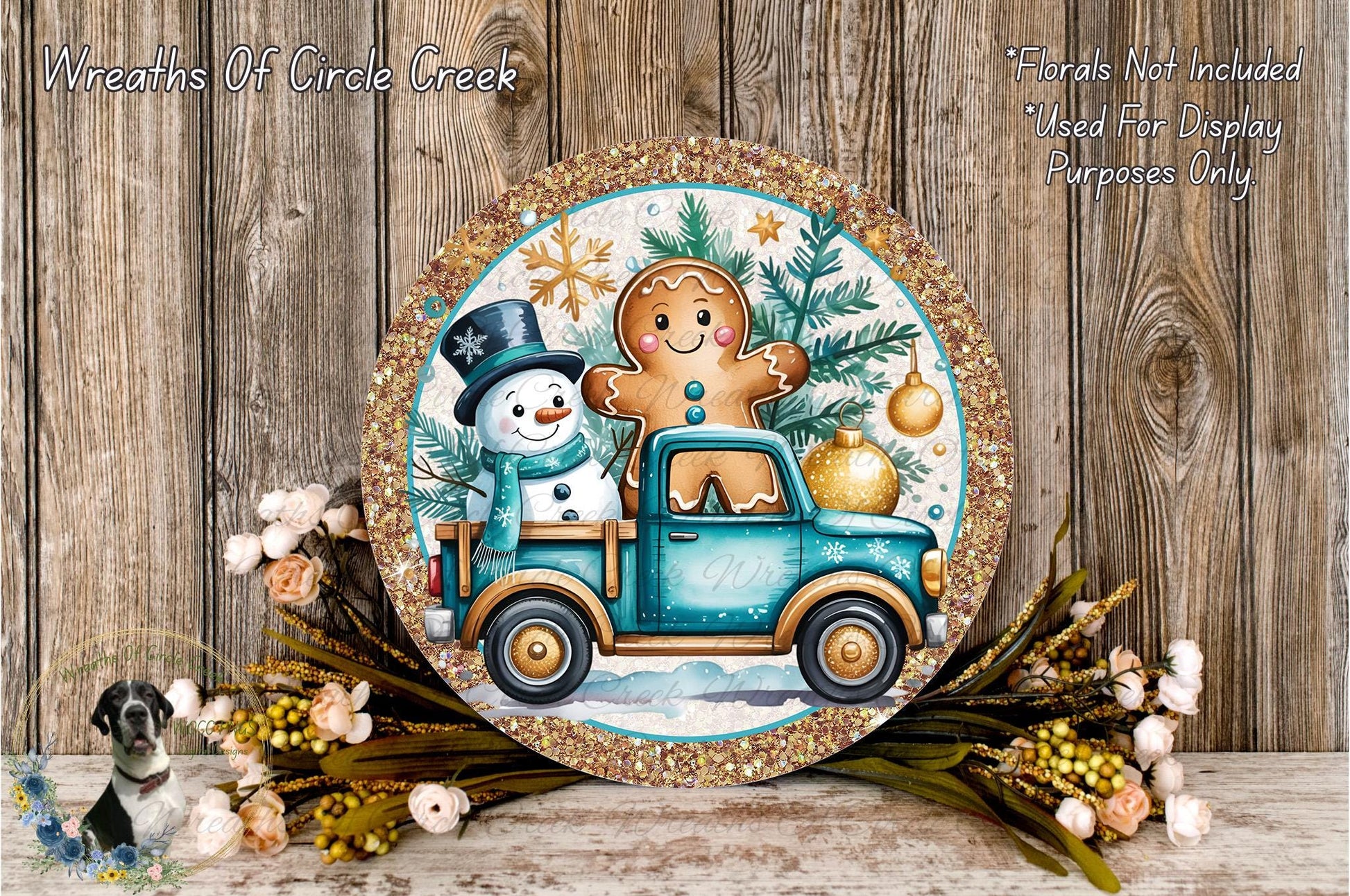 A round decorative plate featuring a snowman and a gingerbread man on a blue truck, surrounded by a wreath of flowers and greenery.