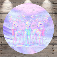 A circular image featuring three deer with antlers, set against a background of a purple and pink color scheme with stars.