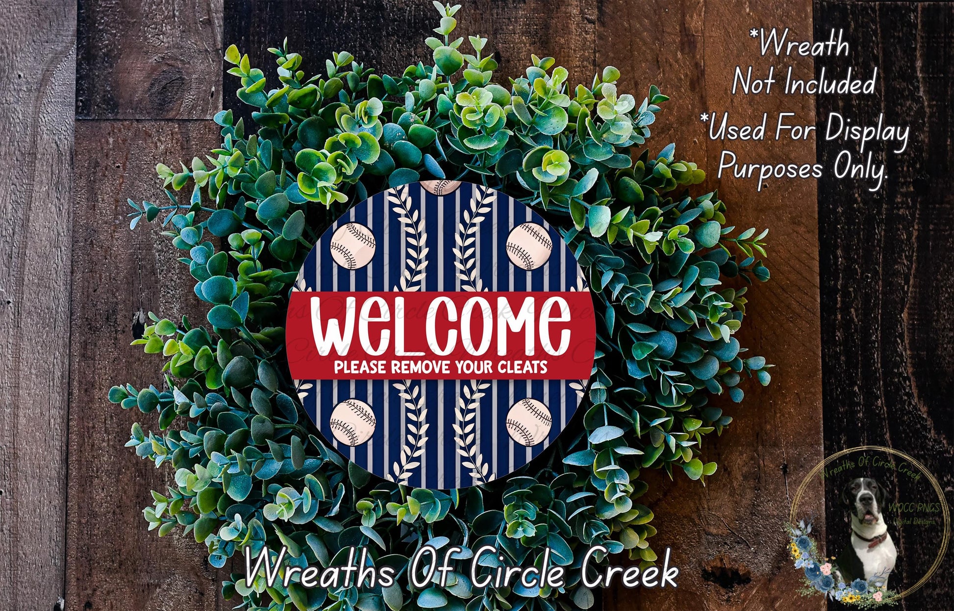 a wreath made of green leaves and a blue sign with the text "Welcome Please remove your cleats" in the center. The wreath is displayed on a wooden surface, and there is a small dog in the bottom right corner.