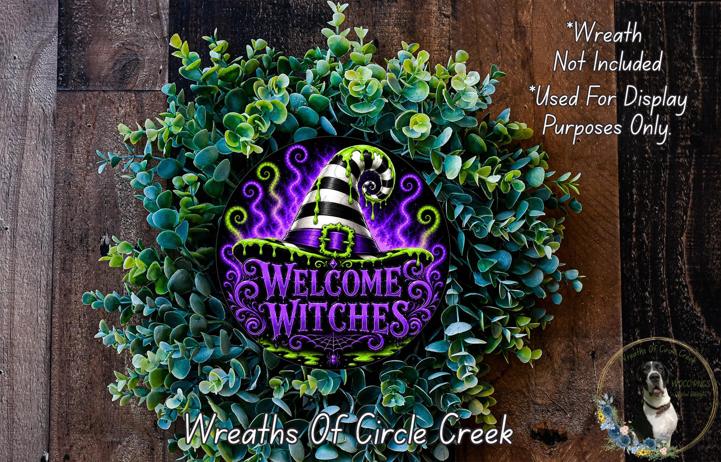 a wreath with a purple and green design, surrounded by greenery, and a sign that reads "Welcome Witches".