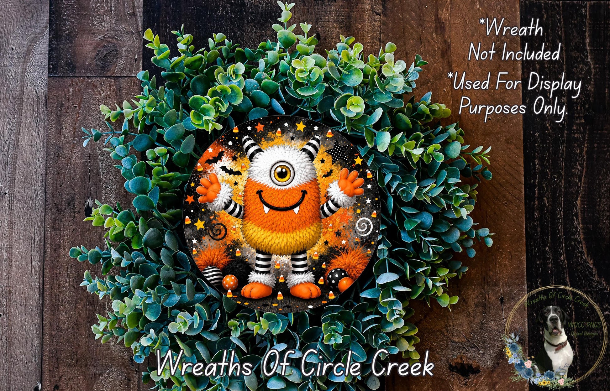 A wreath made of green leaves and featuring a large, colorful monster with a yellow eye and orange and black striped body.