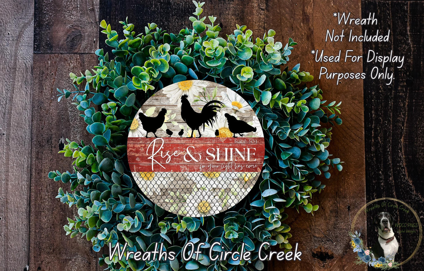 a wreath made of green foliage and a circular sign with the text "Rise & Shine" and a rooster silhouette. The sign is surrounded by a lush wreath, creating a decorative and festive display.