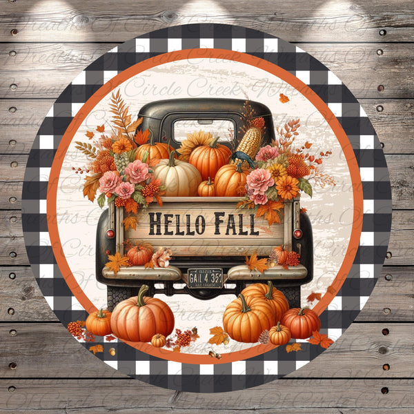 A vintage truck decorated with fall foliage, pumpkins, and flowers, with the text "Hello Fall" displayed on the back.