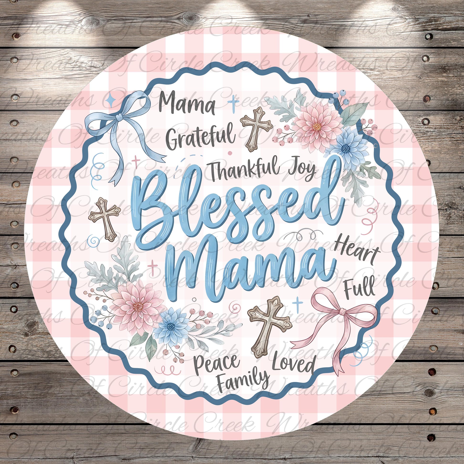 A round, decorative graphic with the text "Blessed Mama" surrounded by floral elements and crosses.