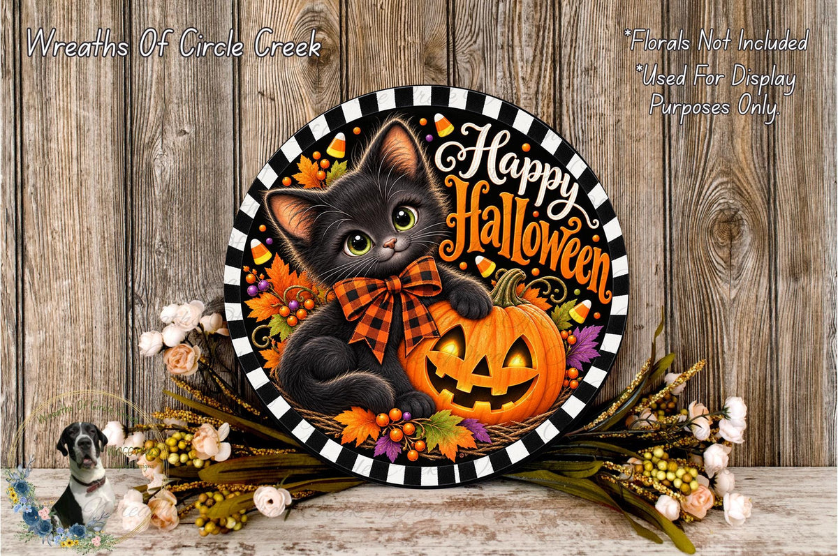 A Halloween-themed wreath featuring a black cat holding a carved pumpkin, surrounded by autumn leaves and flowers. The wreath is displayed on a wooden surface, with a text overlay that reads "Wreaths Of Circle Creek" and "Happy Halloween".