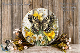 A decorative wreath featuring a butterfly and yellow flowers, placed on a wooden surface.