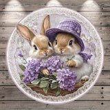 A pair of rabbits wearing purple hats and sitting in a basket filled with purple flowers.