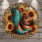 A round, leopard print-patterned mat with a cowboy hat and boots placed on it, surrounded by sunflowers.