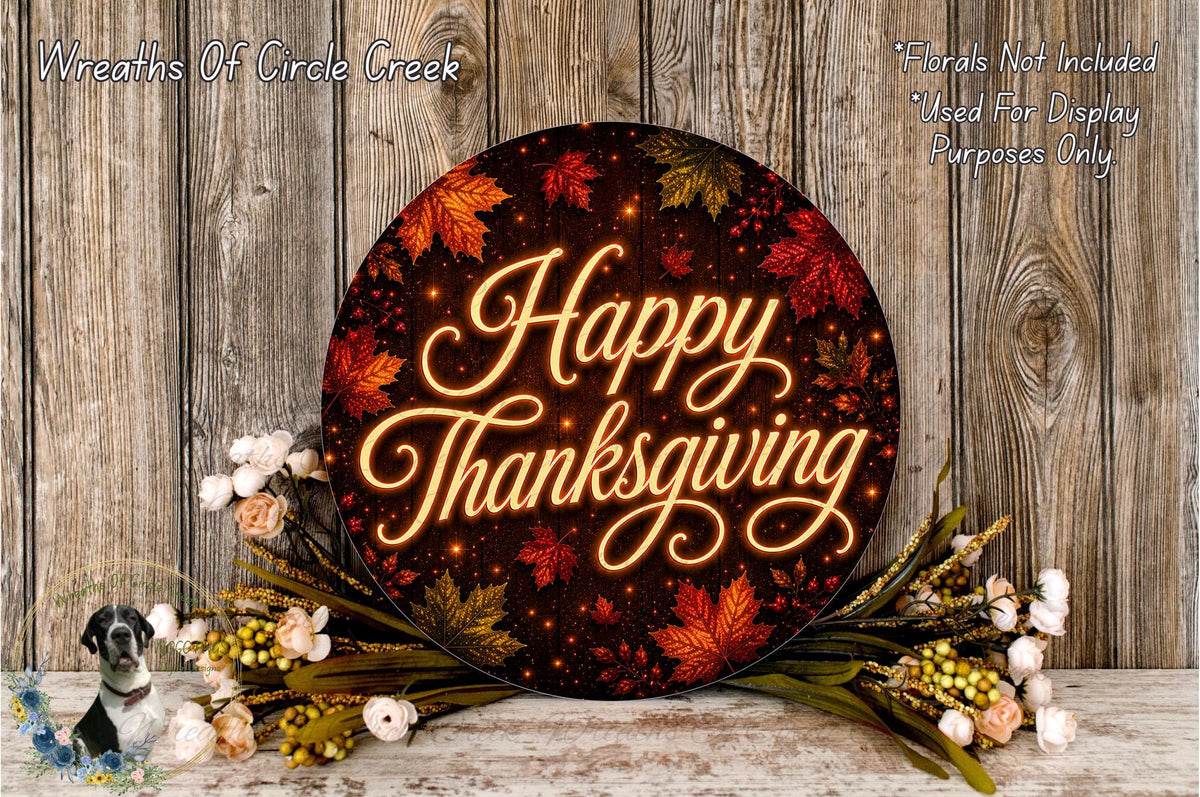 A circular sign with the text "Happy Thanksgiving" surrounded by autumn leaves and flowers, placed on a wooden surface.