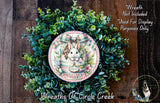 a wreath with a bunny and the word "Easter" on it, surrounded by a lush green plant. The wreath is displayed on a wooden surface, and there is a text overlay that reads "Wreath Not Included * Used For Display Purposes Only".