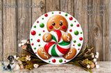 A gingerbread man figure holding a candy cane is displayed on a white plate, surrounded by a wreath of flowers and greenery against a wooden background.