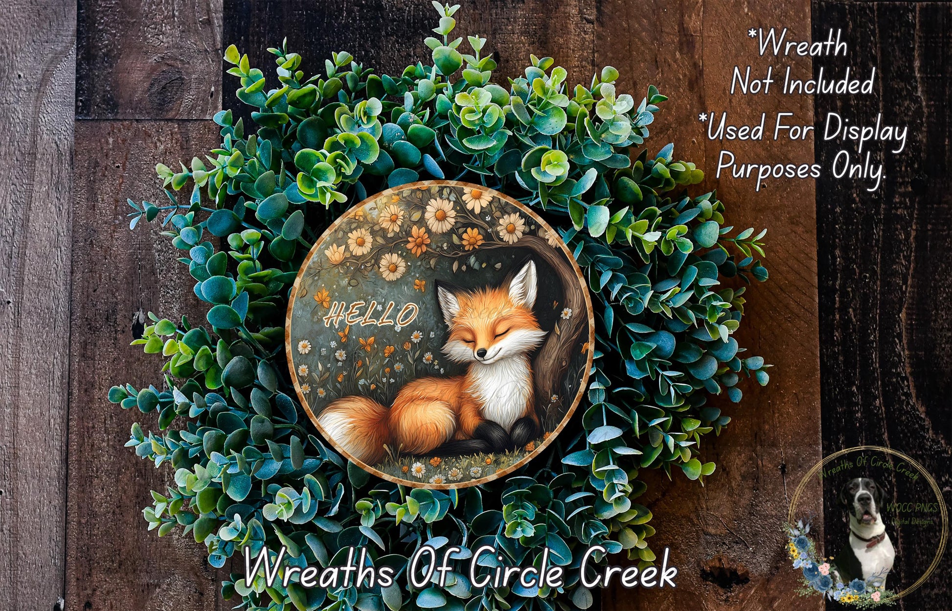 A wreath made of green plants and flowers, with a fox sleeping in the center. The fox is surrounded by the greenery, and the word "Hello" is written on the wreath.