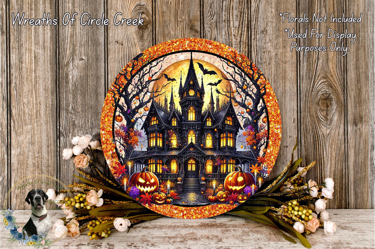 a Halloween-themed wreath with a castle, pumpkins, and bats, set against a wooden background.